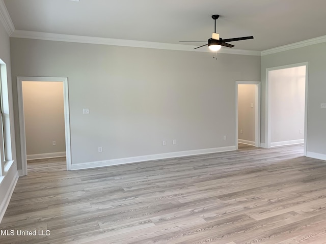 empty room featuring crown molding, a ceiling fan, baseboards, and light wood-type flooring