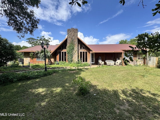 5114 Bay St, Pascagoula, MS 39567 - back of house featuring metal roof and a chimney