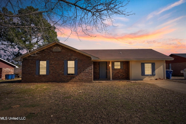 ranch-style house featuring a lawn