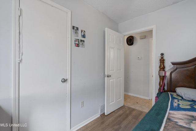 bedroom with dark wood-type flooring