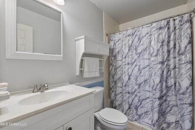 bathroom with toilet, vanity, and a shower with curtain