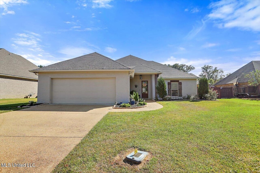 view of front facade featuring a front yard and a garage