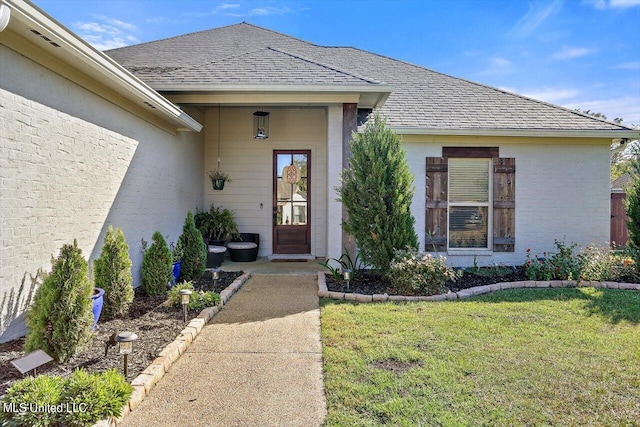 entrance to property with a yard