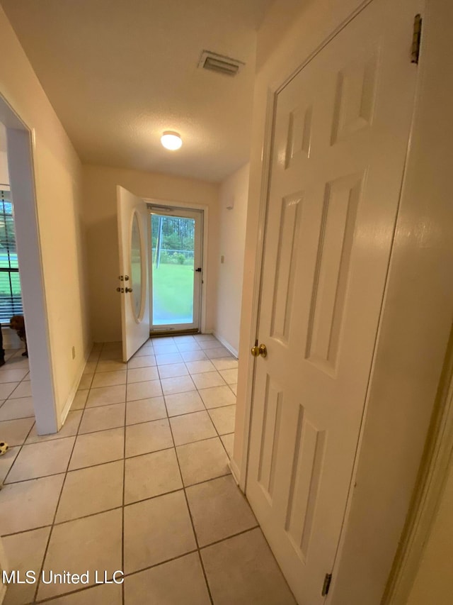 hallway with light tile patterned floors