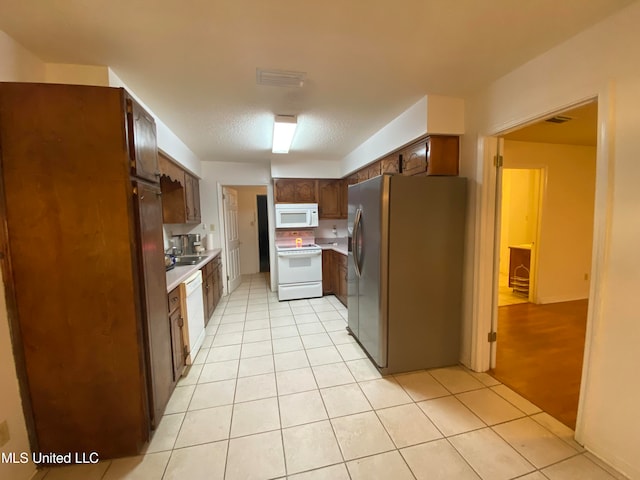 kitchen featuring white appliances and light hardwood / wood-style floors