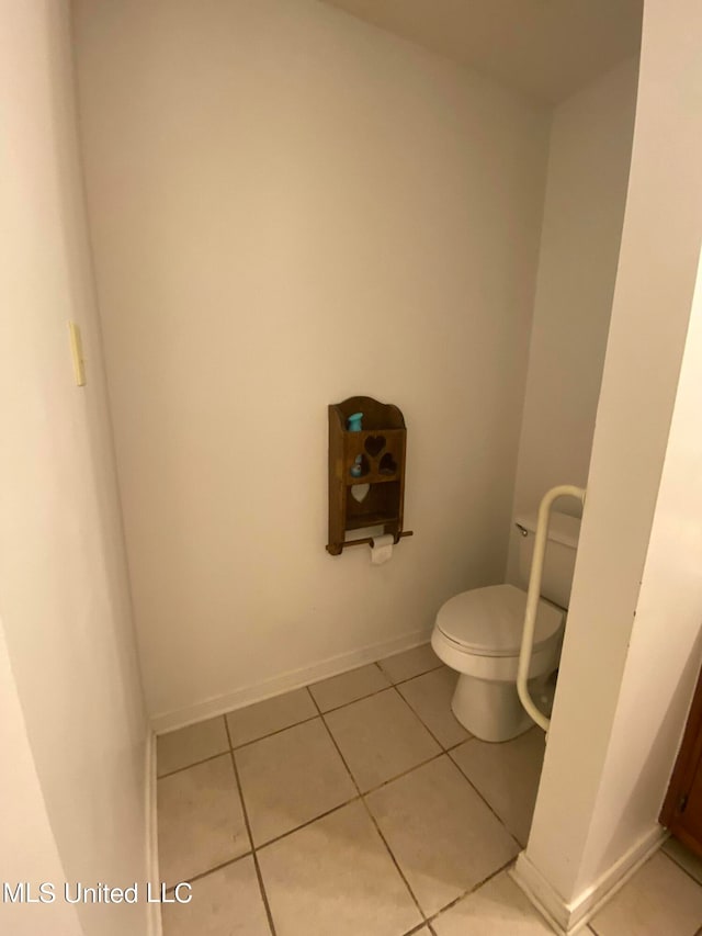 bathroom featuring toilet and tile patterned floors