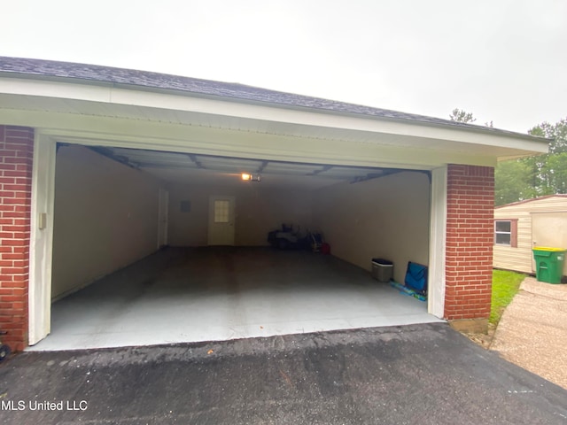 view of vehicle parking with a garage