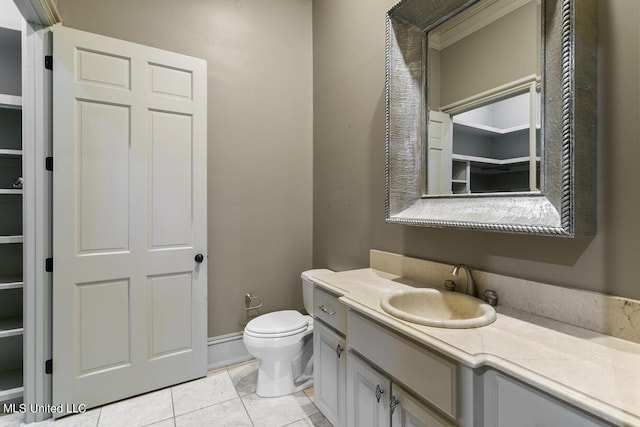 bathroom with vanity, tile patterned floors, and toilet