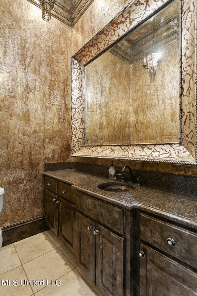 bathroom featuring vanity, tile patterned flooring, and toilet