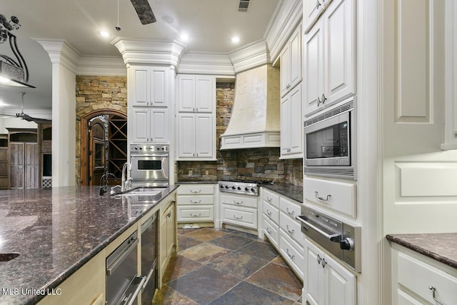 kitchen featuring white cabinetry, appliances with stainless steel finishes, sink, and dark stone countertops