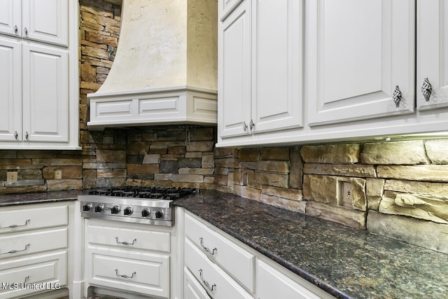 kitchen featuring backsplash, stainless steel gas cooktop, custom exhaust hood, and white cabinets