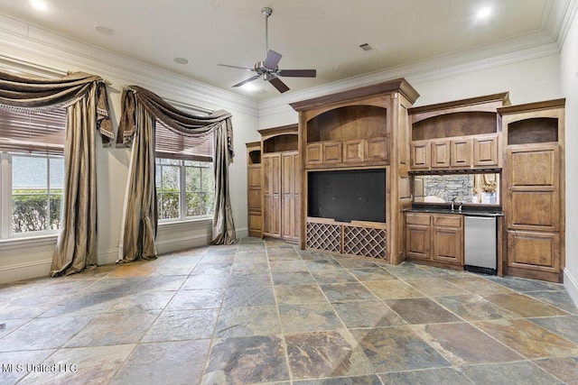 unfurnished living room with ceiling fan and ornamental molding