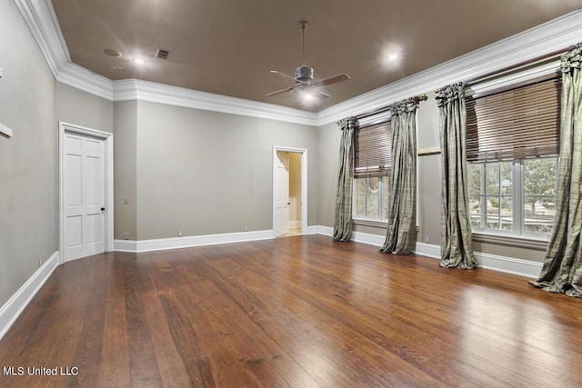 unfurnished room featuring a healthy amount of sunlight, dark hardwood / wood-style floors, and ornamental molding