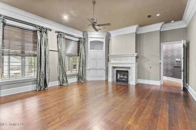 unfurnished living room featuring hardwood / wood-style flooring, ceiling fan, and ornamental molding