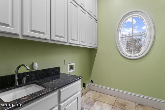 laundry area featuring cabinets, hookup for a washing machine, and sink