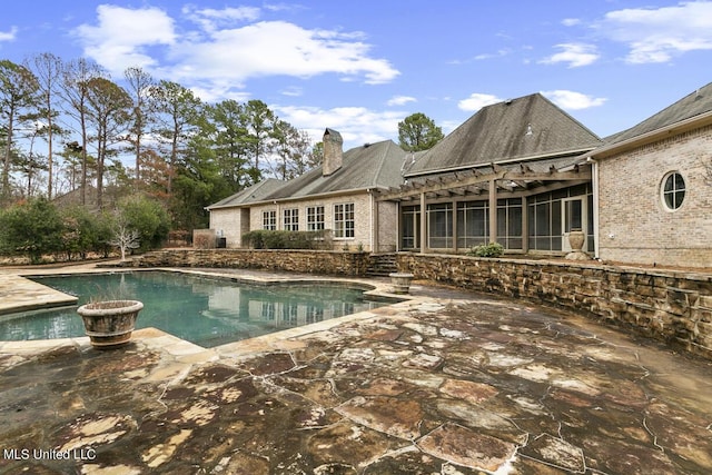 view of swimming pool featuring a pergola and a patio