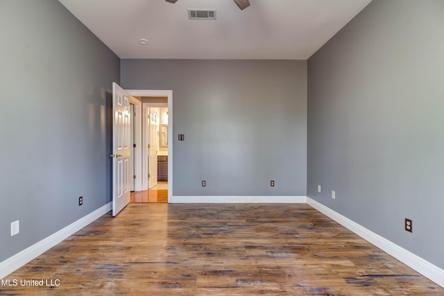 unfurnished bedroom with a ceiling fan, visible vents, baseboards, and wood finished floors