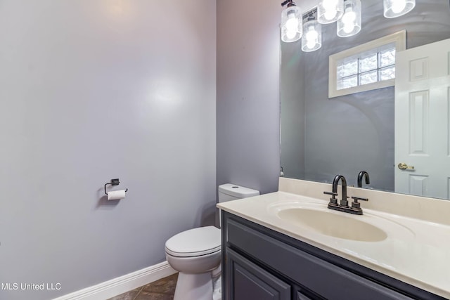 bathroom featuring tile patterned floors, vanity, toilet, and baseboards