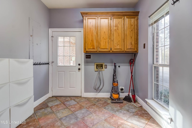 clothes washing area with baseboards, hookup for a washing machine, cabinet space, and hookup for an electric dryer