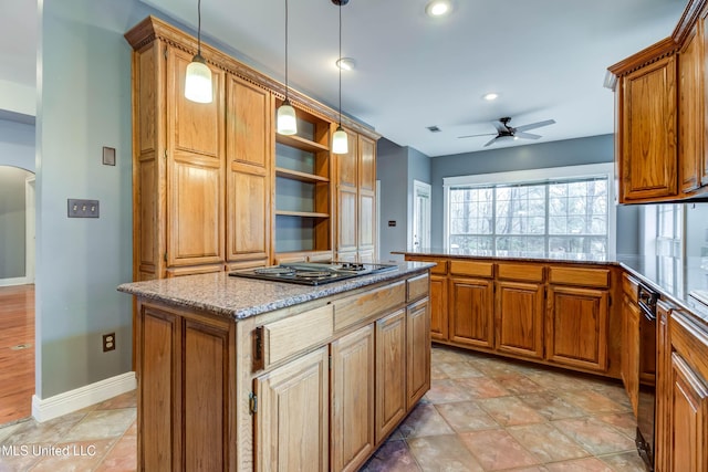 kitchen with arched walkways, brown cabinets, black electric stovetop, a ceiling fan, and a peninsula