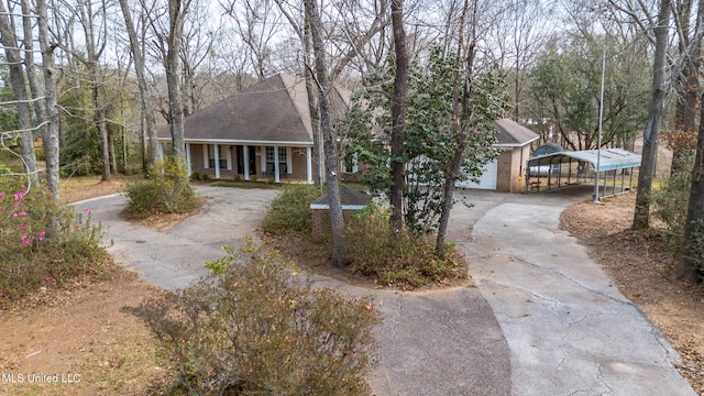 view of front of home with a carport, driveway, a porch, and brick siding