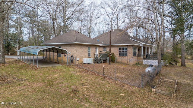 view of side of home featuring driveway, a carport, and brick siding