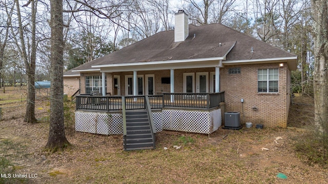 rear view of property with brick siding, a chimney, central air condition unit, a porch, and crawl space