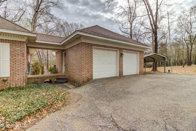 view of side of home with brick siding, roof with shingles, and aphalt driveway