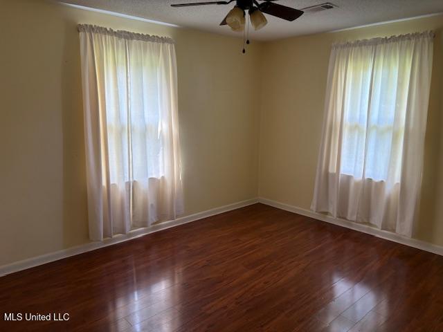 3 Pemberton Cir, Greenwood, MS 38930 - unfurnished room with ceiling fan, wood finished floors, and baseboards