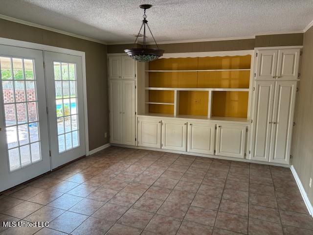 3 Pemberton Cir, Greenwood, MS 38930 - unfurnished dining area with a textured ceiling, ornamental molding, light tile patterned floors, baseboards, and a chandelier