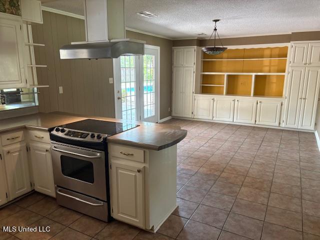 3 Pemberton Cir, Greenwood, MS 38930 - kitchen featuring stainless steel range with electric stovetop, range hood, open shelves, a peninsula, and white cabinetry