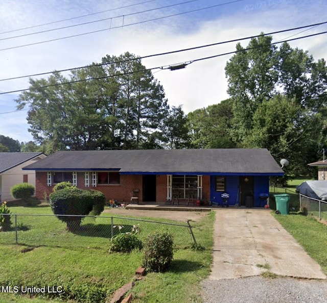 ranch-style home with a fenced front yard, a front yard, and brick siding