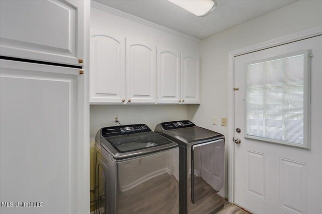 110 Stonington Ct, Brandon, MS 39047 - laundry area with washing machine and dryer, cabinet space, and wood finished floors