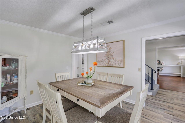 110 Stonington Ct, Brandon, MS 39047 - dining room with wood finished floors, crown molding, a textured ceiling, and stairway