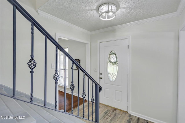110 Stonington Ct, Brandon, MS 39047 - entryway featuring a textured ceiling, stairway, wood finished floors, and crown molding