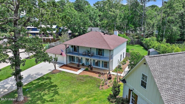 110 Stonington Ct, Brandon, MS 39047 - view of front of property with concrete driveway, a balcony, a front yard, roof with shingles, and a chimney