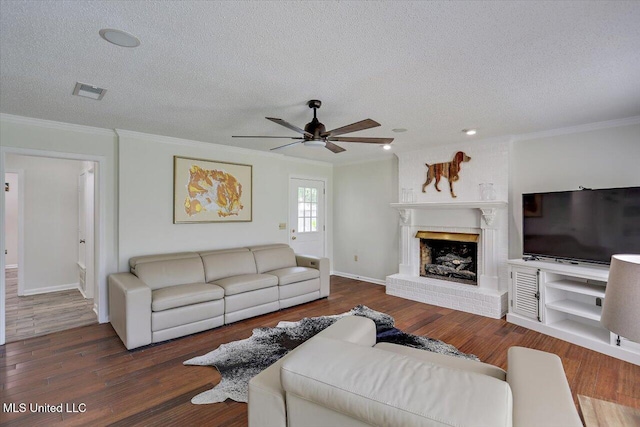 110 Stonington Ct, Brandon, MS 39047 - living room featuring a textured ceiling, ornamental molding, ceiling fan, a fireplace, and wood finished floors