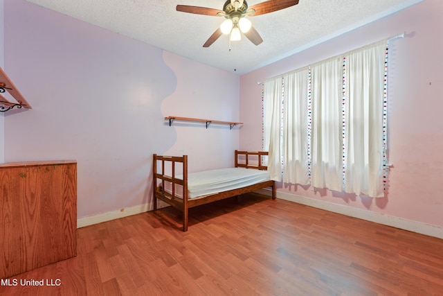 4006 Pine St, Pascagoula, MS 39567 - bedroom featuring wood finished floors, a textured ceiling, and a ceiling fan