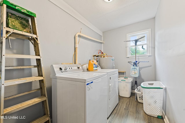 4006 Pine St, Pascagoula, MS 39567 - washroom with washing machine and clothes dryer, water heater, and wood finished floors