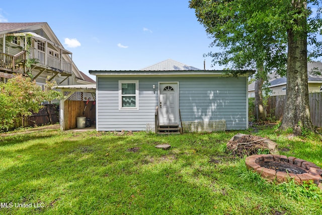 4006 Pine St, Pascagoula, MS 39567 - back of house with an outdoor fire pit, a fenced backyard, entry steps, and an outdoor structure
