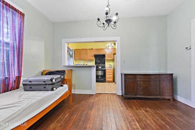 4006 Pine St, Pascagoula, MS 39567 - bedroom with a chandelier, dark wood finished floors, and freestanding refrigerator