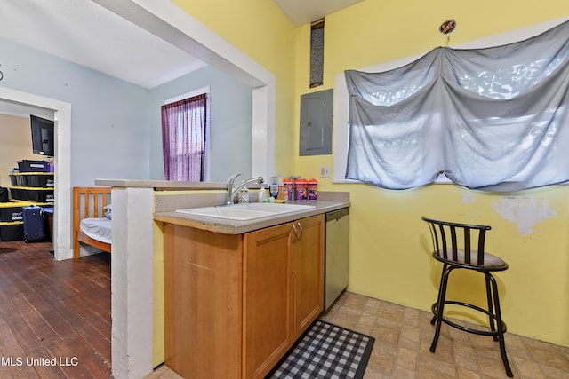 4006 Pine St, Pascagoula, MS 39567 - kitchen featuring electric panel, stainless steel dishwasher, light countertops, a peninsula, and brown cabinets