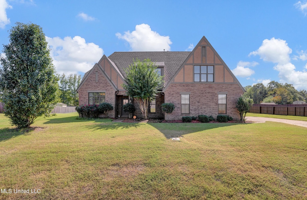 english style home with a front lawn