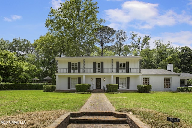 3831 Tyrone Dr, Jackson, MS 39216 - view of front of property featuring a front lawn, a balcony, french doors, and a chimney