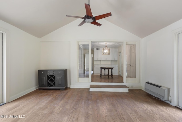 3831 Tyrone Dr, Jackson, MS 39216 - unfurnished living room featuring vaulted ceiling, ceiling fan, wood finished floors, a chandelier, and heating unit