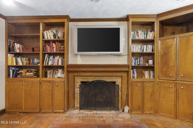 3831 Tyrone Dr, Jackson, MS 39216 - living area with light wood-type flooring, a fireplace, and a textured ceiling