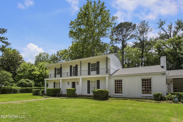 3831 Tyrone Dr, Jackson, MS 39216 - view of front of house with a front lawn, a balcony, covered porch, roof with shingles, and a chimney