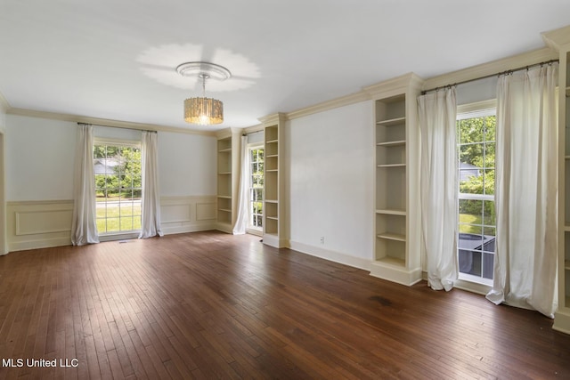 3831 Tyrone Dr, Jackson, MS 39216 - spare room featuring dark wood-style floors, healthy amount of natural light, a wainscoted wall, a chandelier, and built in features