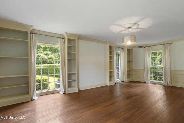 3831 Tyrone Dr, Jackson, MS 39216 - unfurnished room featuring wood-type flooring, plenty of natural light, a wainscoted wall, and a chandelier
