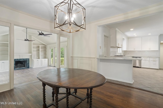 3831 Tyrone Dr, Jackson, MS 39216 - dining area with ceiling fan, wood finished floors, crown molding, a chandelier, and a fireplace
